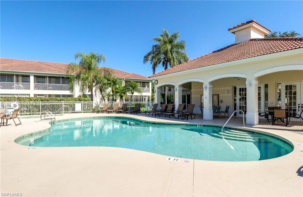 a view of a house with swimming pool and a yard