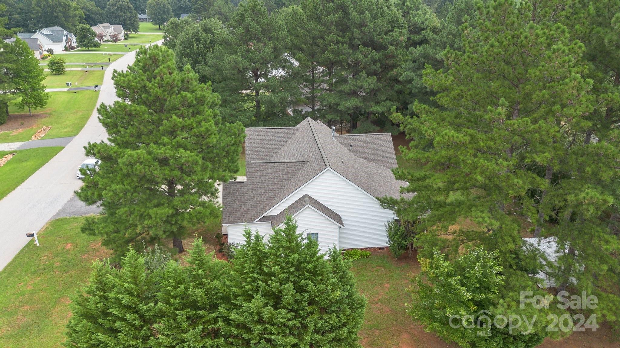 a aerial view of a house with swimming pool and garden