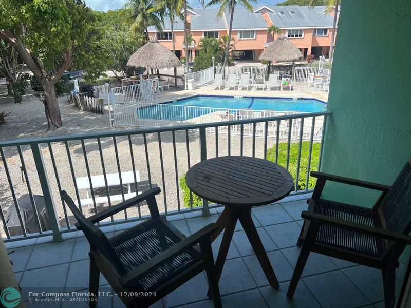 a view of a balcony with chairs