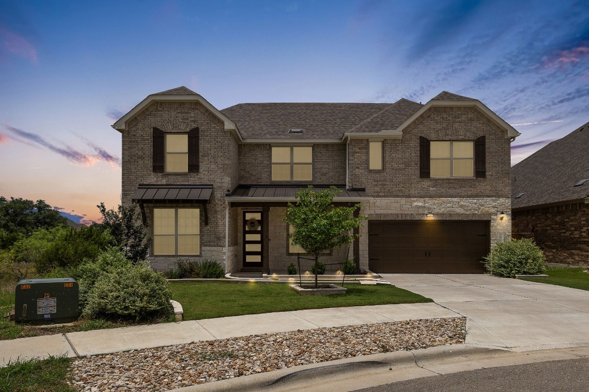 a front view of a house with a yard and garage