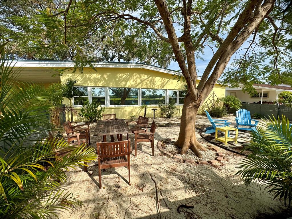 a view of a swimming pool with outdoor seating and plants