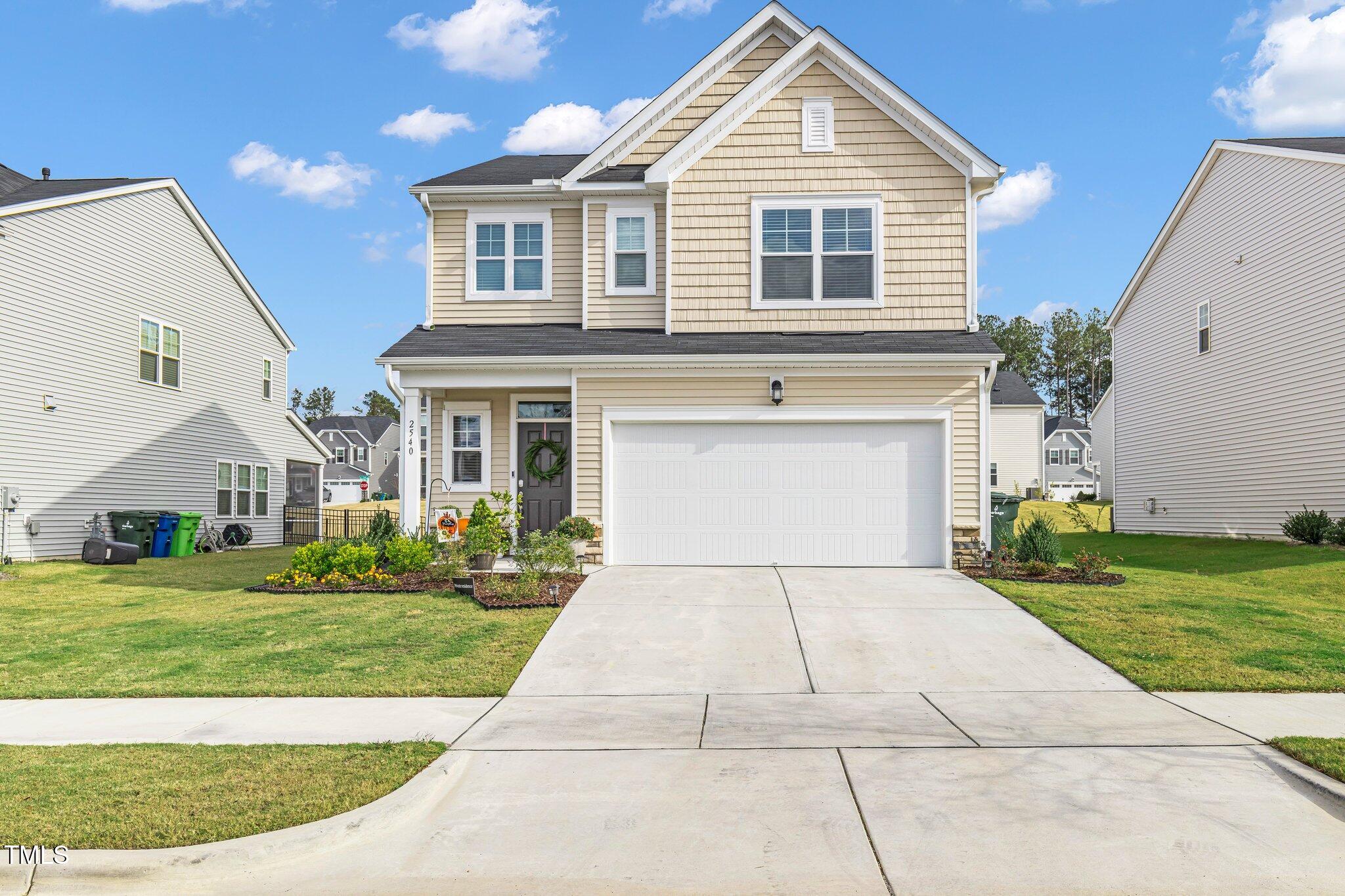 a front view of a house with a yard