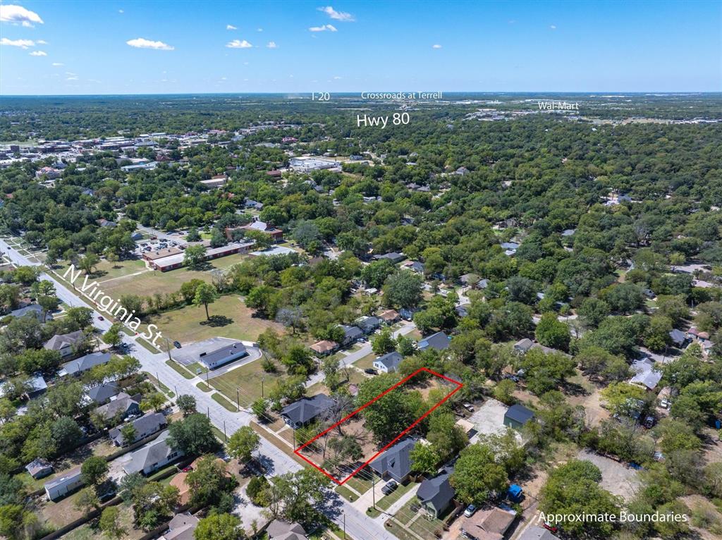 an aerial view of a city with lots of residential buildings and mountain view in back