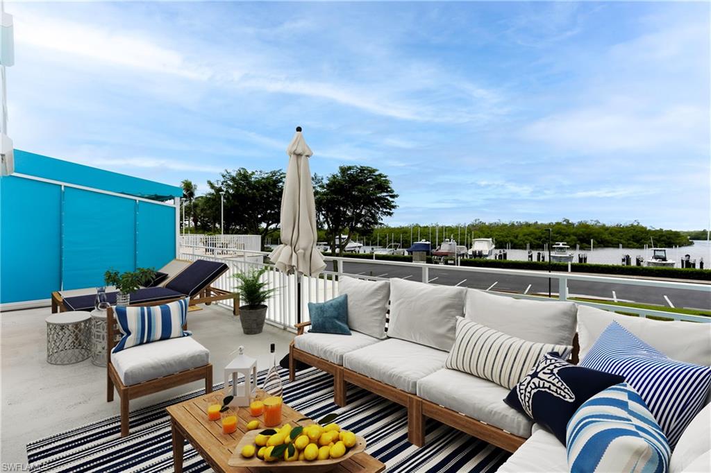 an outdoor living room with patio furniture and a potted plant