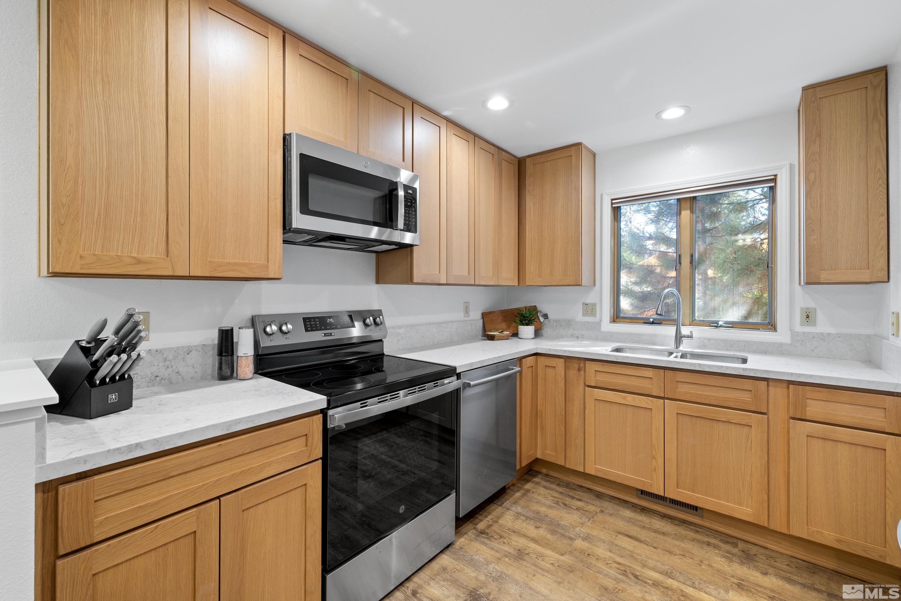 a kitchen with a sink stove and microwave