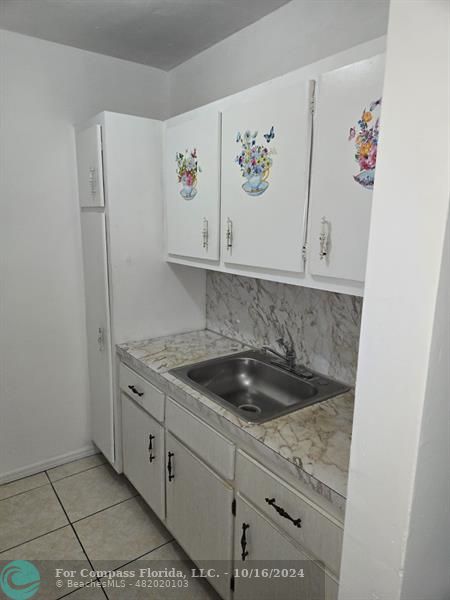 a kitchen with a sink and cabinets