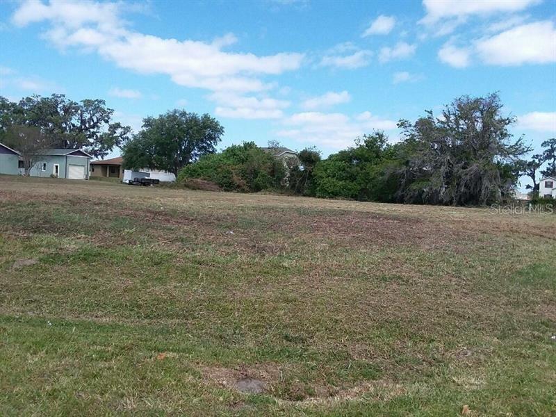 a view of outdoor space with green field and trees