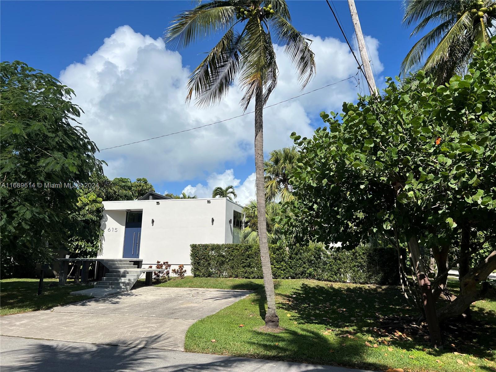 a view of a house with a yard and garage