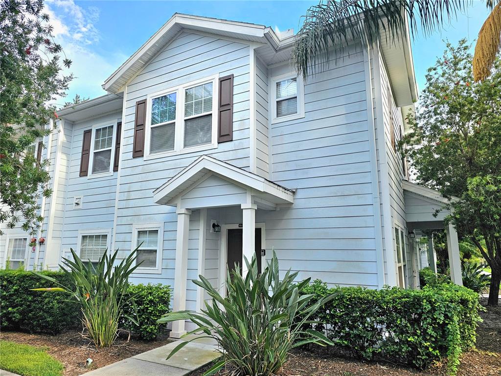 a front view of a house with a tree