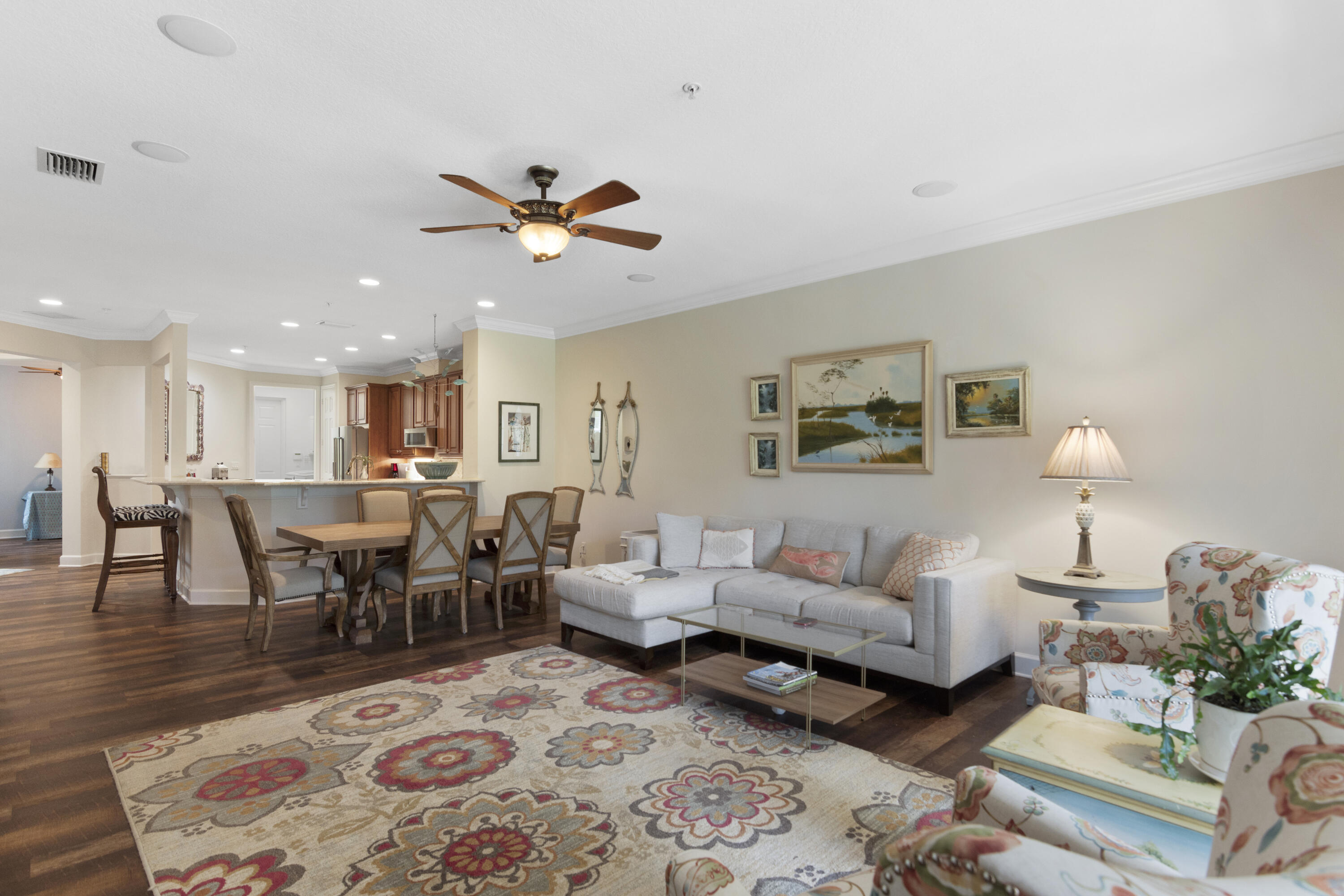 a living room with furniture a rug and a chandelier