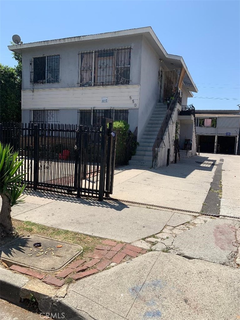 a view of a house with wooden floor and a bench