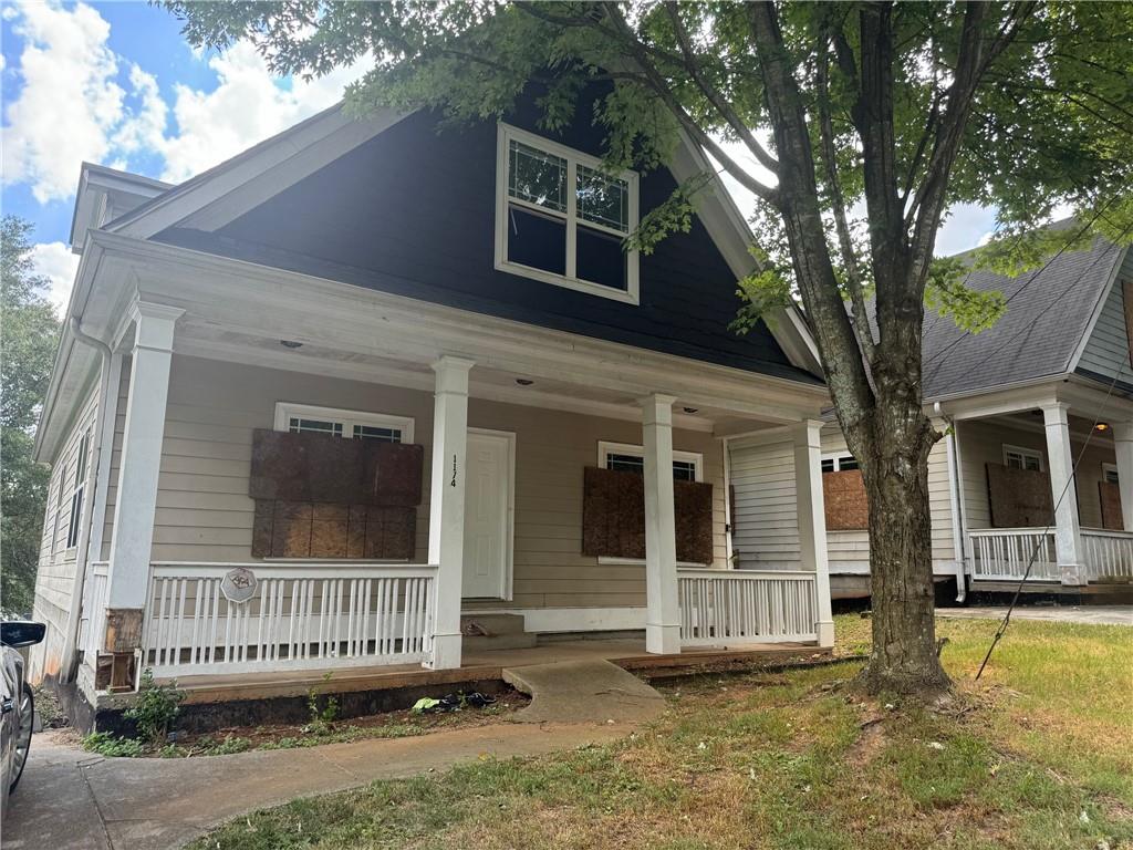 a view of a house with a large window and wooden fence