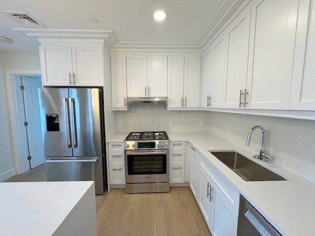 a kitchen with a sink stove and refrigerator