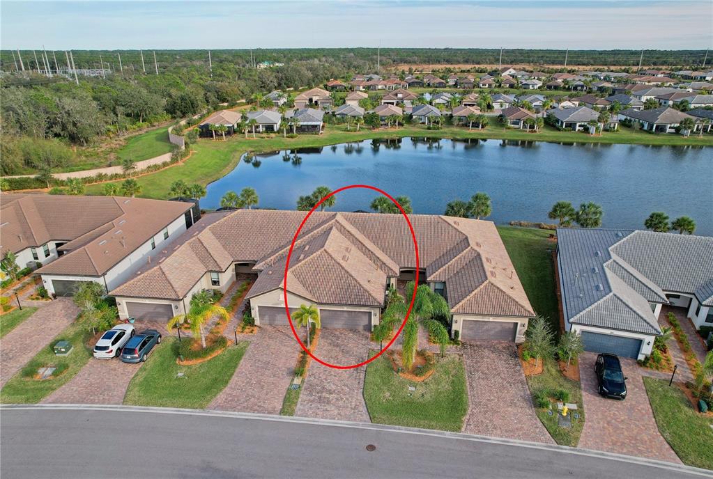 an aerial view of residential houses with outdoor space and river