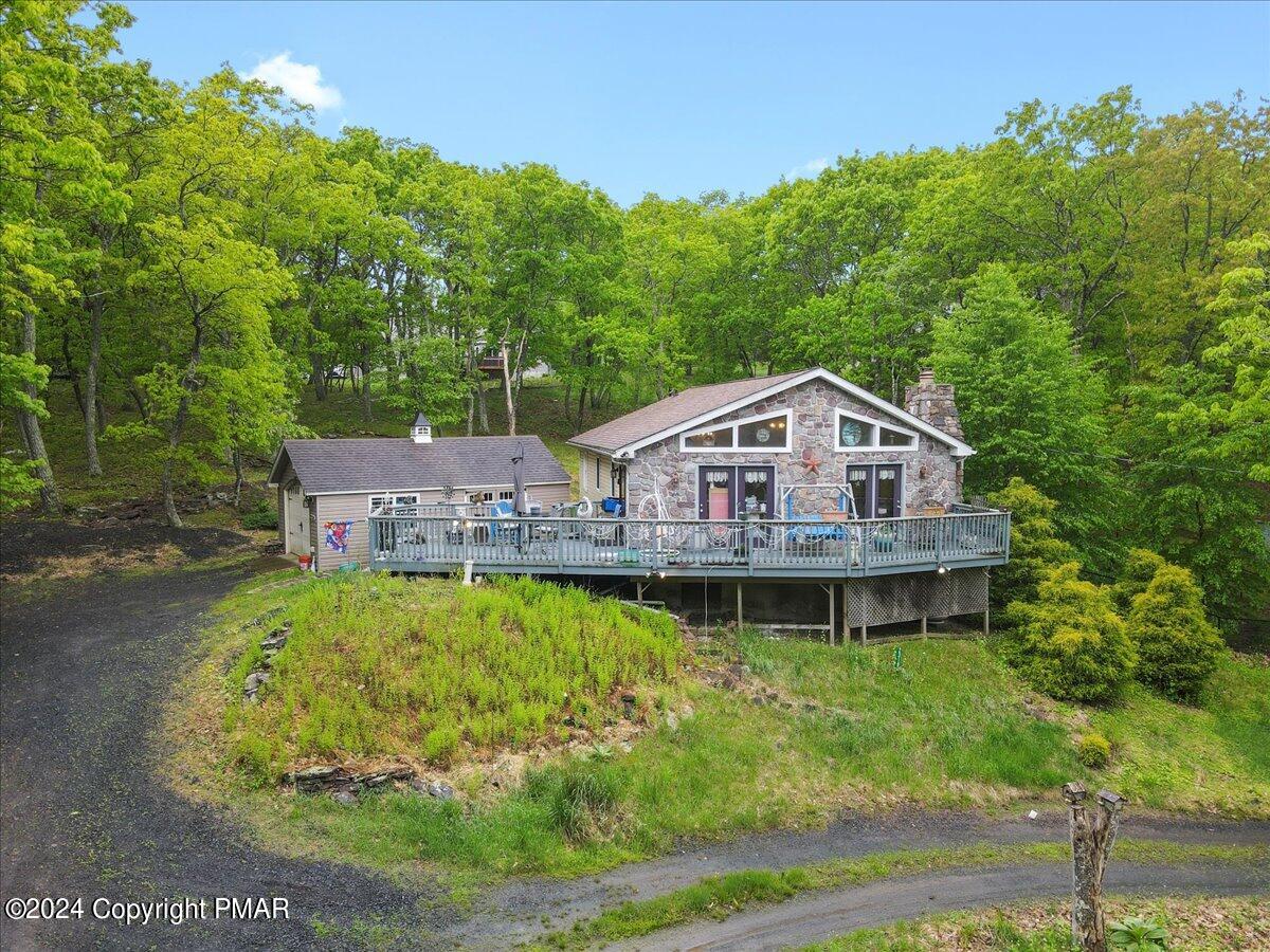 a aerial view of a house with swimming pool next to a yard