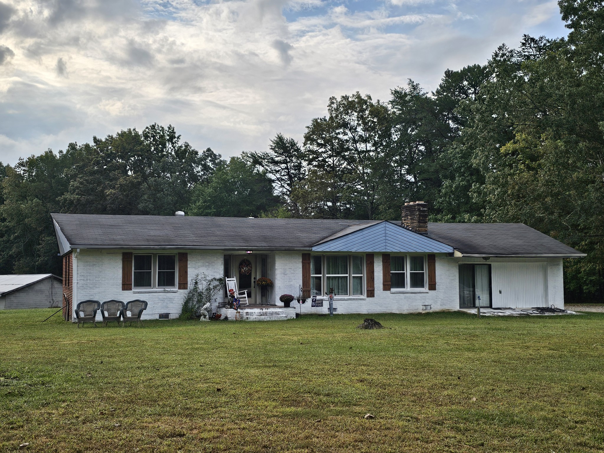 a front view of a house with a garden