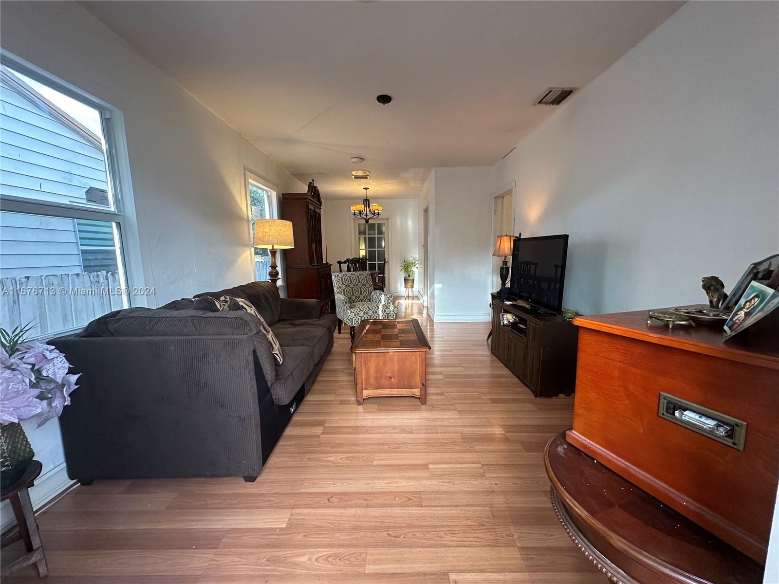 a living room with furniture flat screen tv and a fireplace