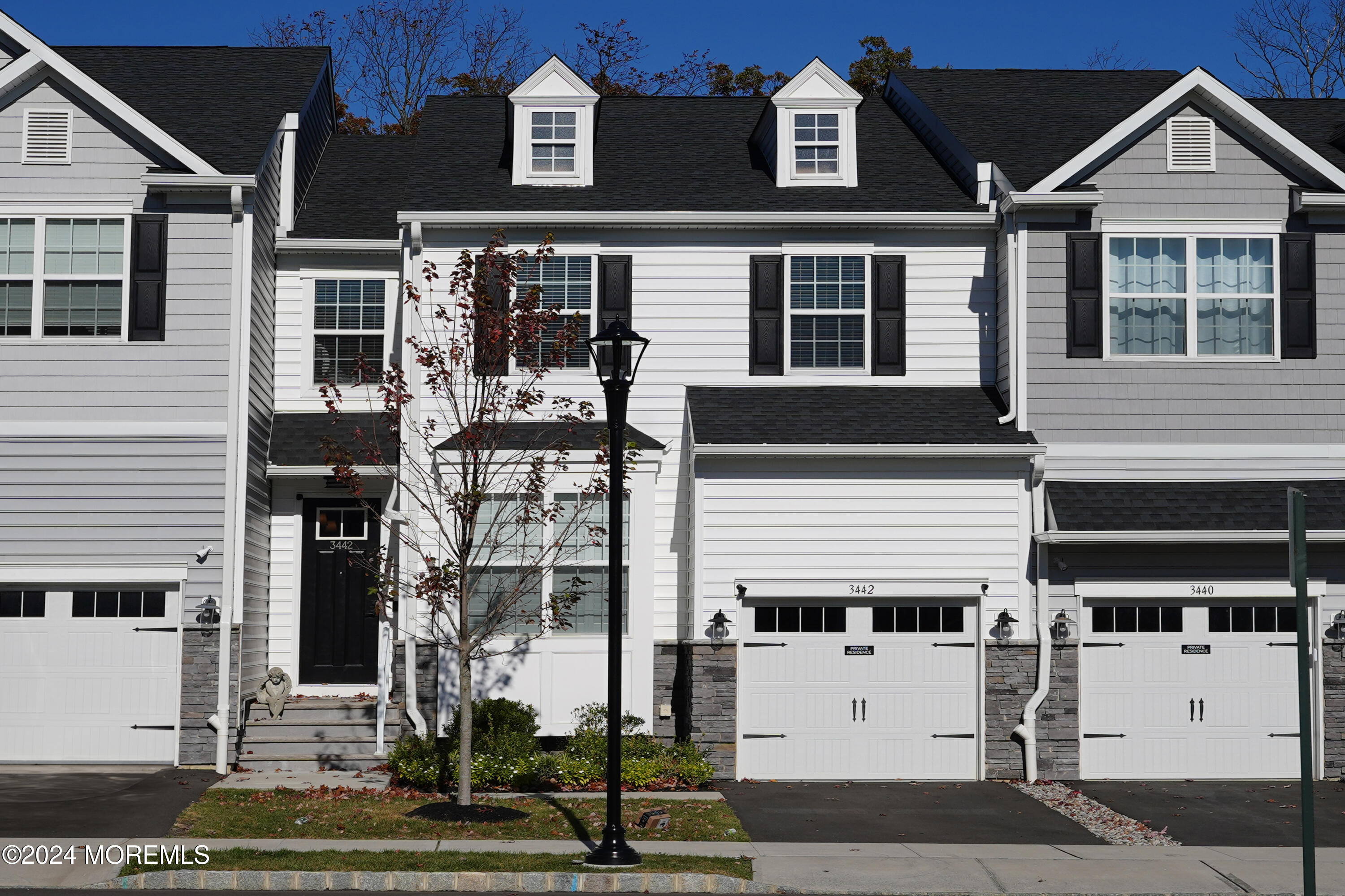 a front view of a house with a street