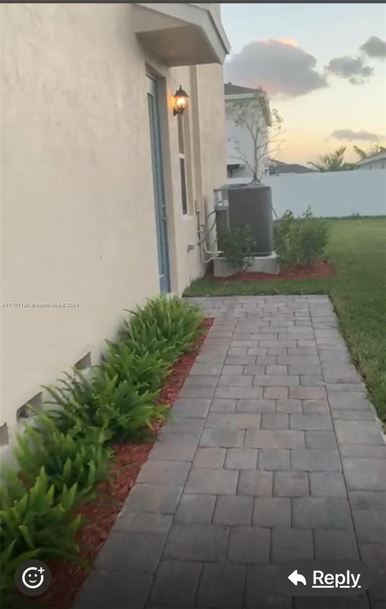 a view of a pathway both side of house