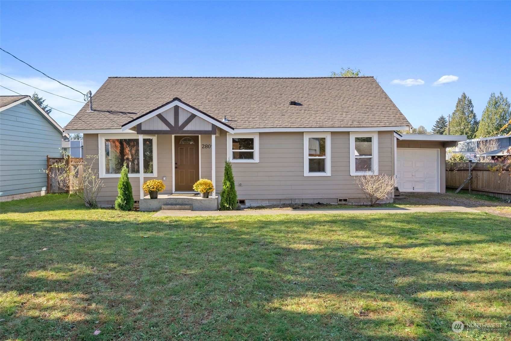 a front view of a house with a garden and porch