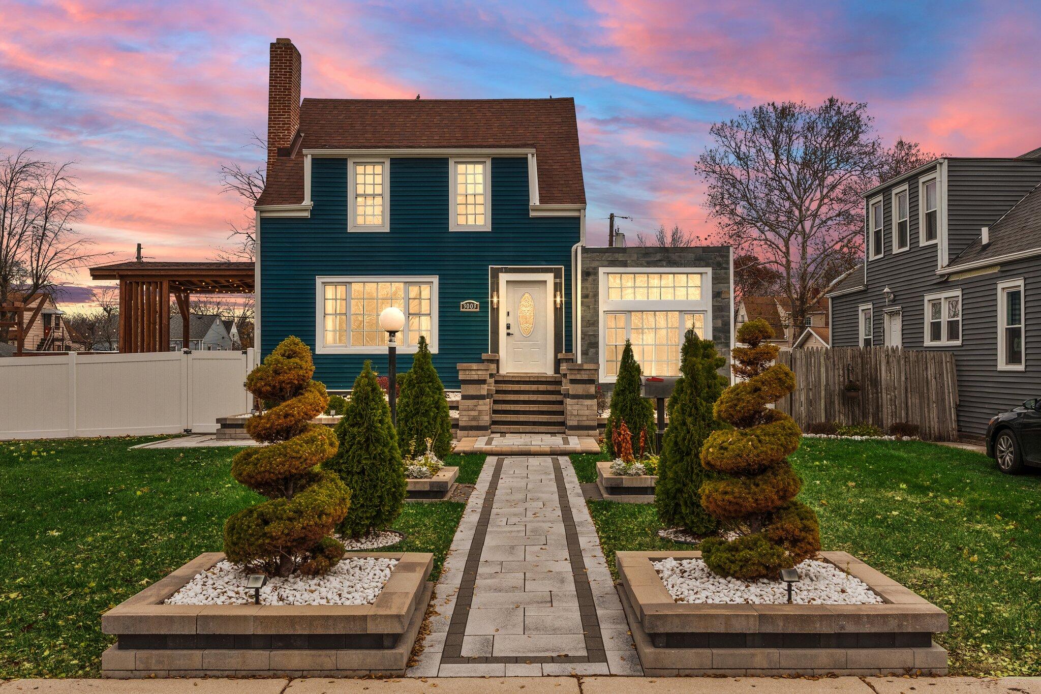 a front view of a house with a yard