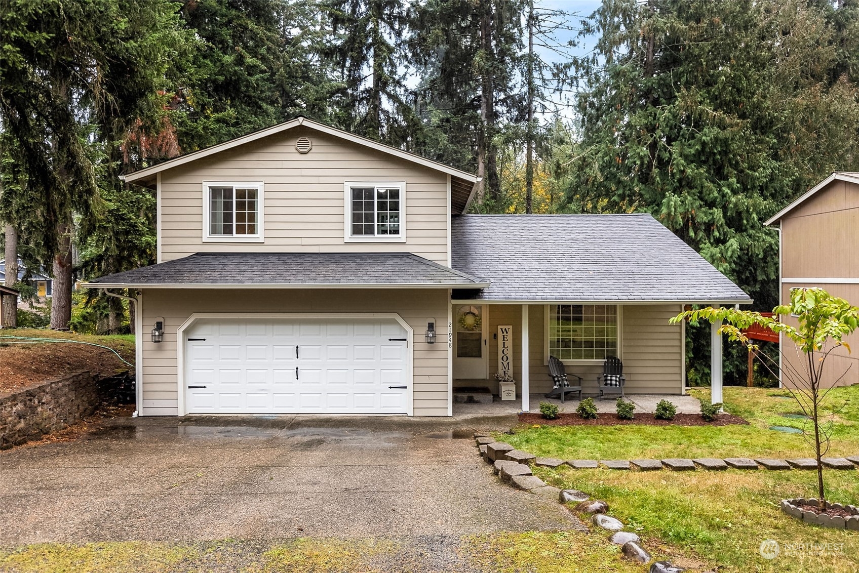 a front view of a house with a yard and garage