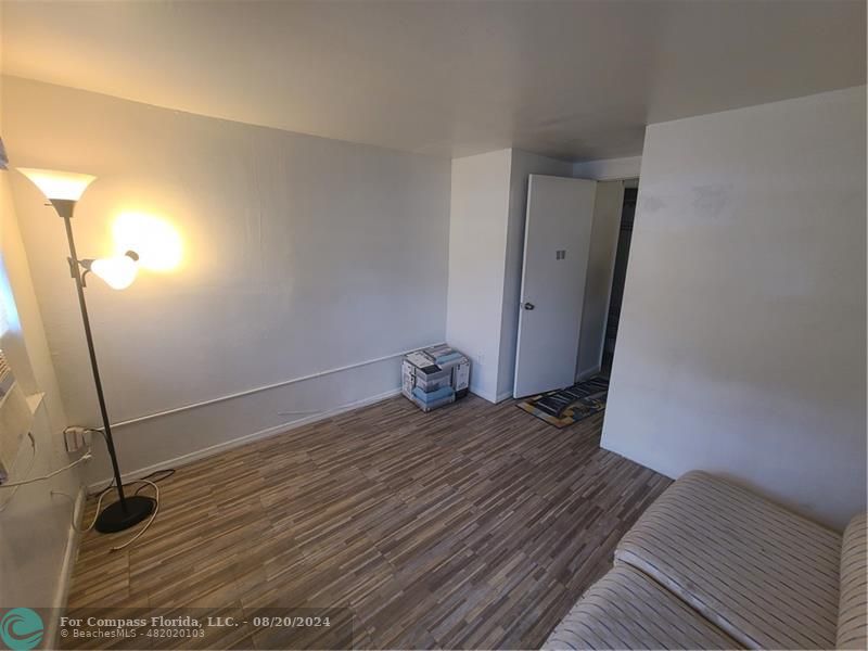 a view of a room with wooden floor