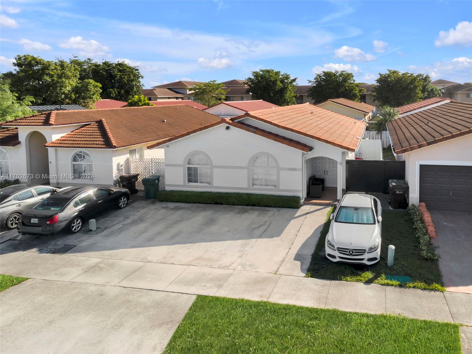 a white building that has a sink and a yard