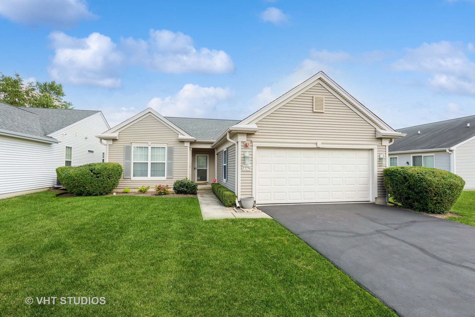 a front view of a house with a yard and garage