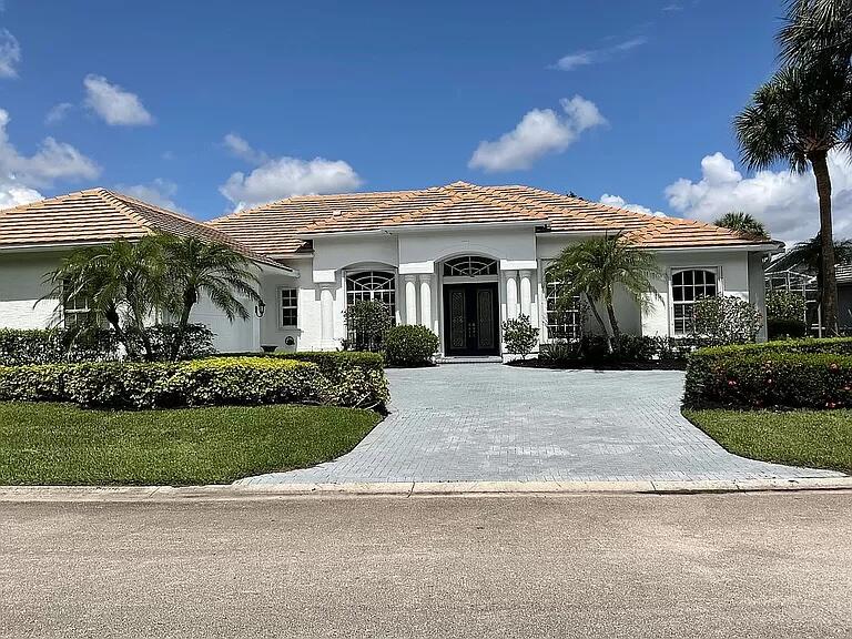 a view of a white house with a yard