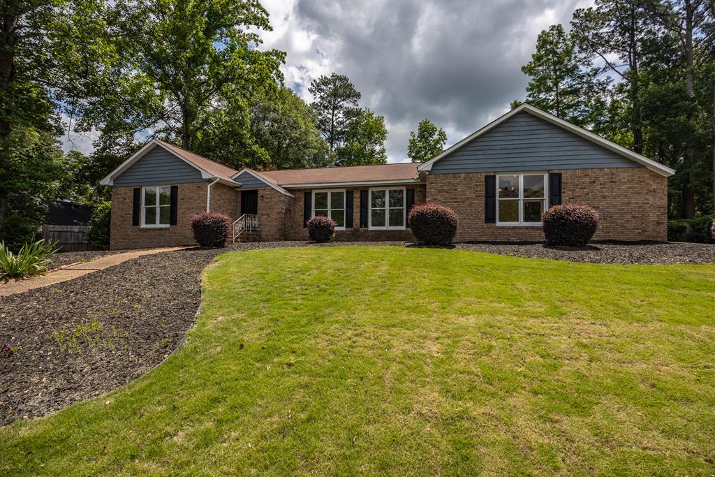 a front view of house with yard and green space