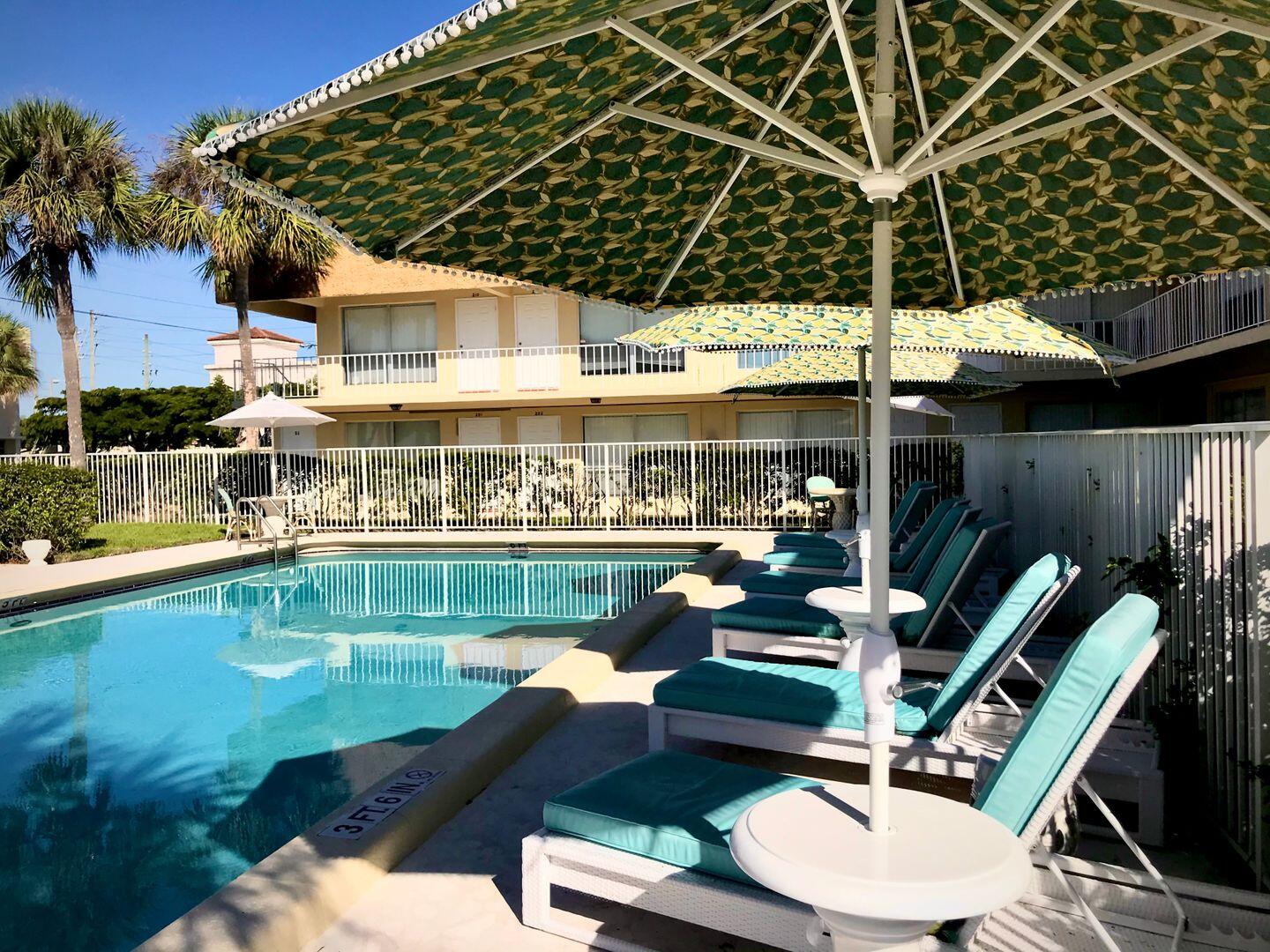 a view of a swimming pool with outdoor seating