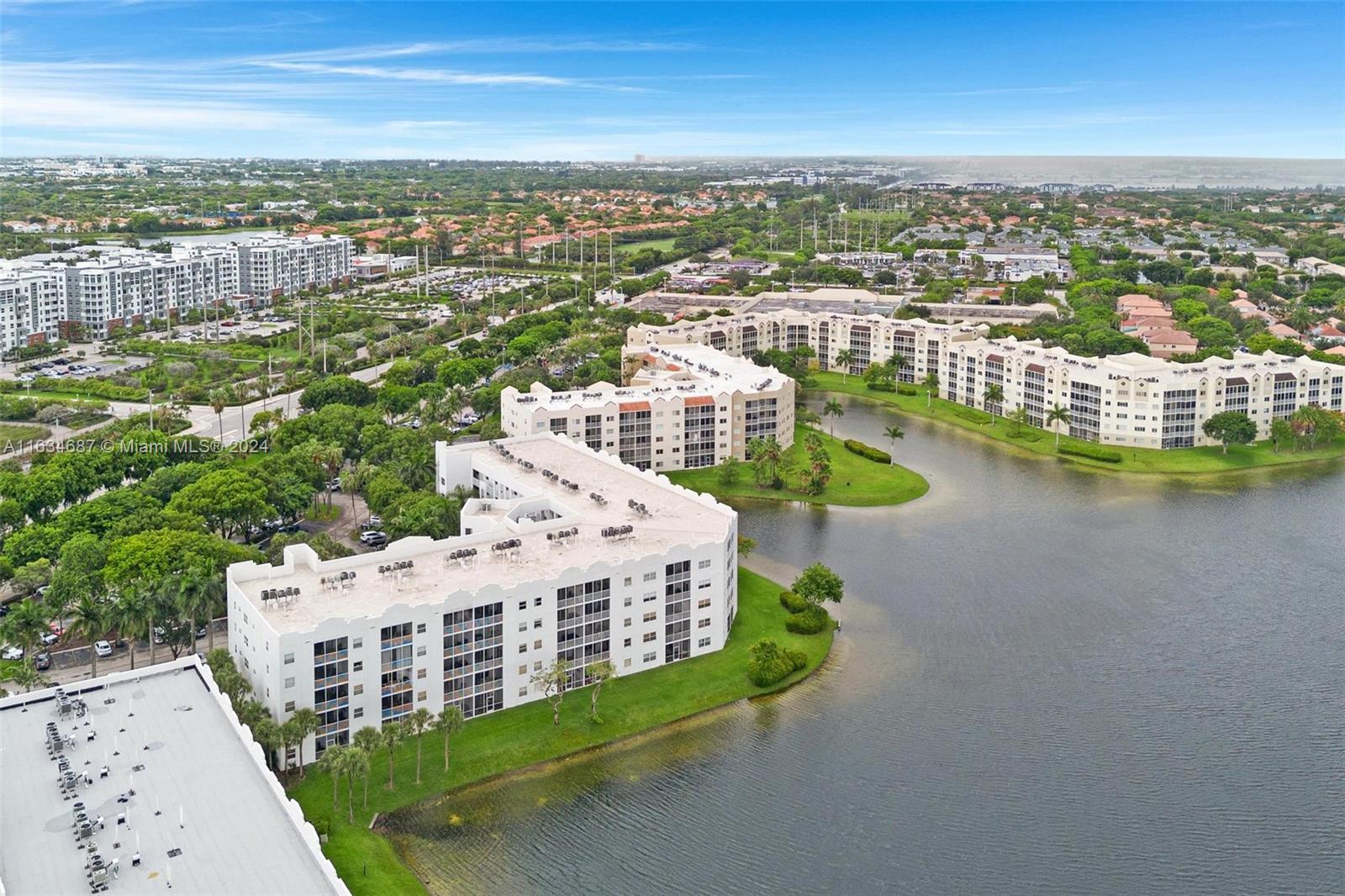 an aerial view of residential houses with outdoor space and ocean view