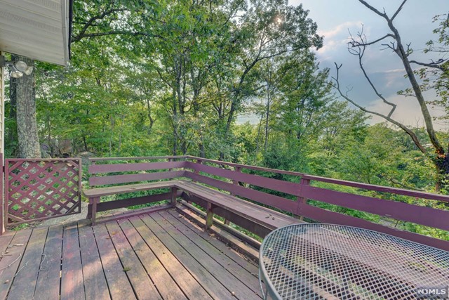 a view of a roof deck with wooden floor and fence