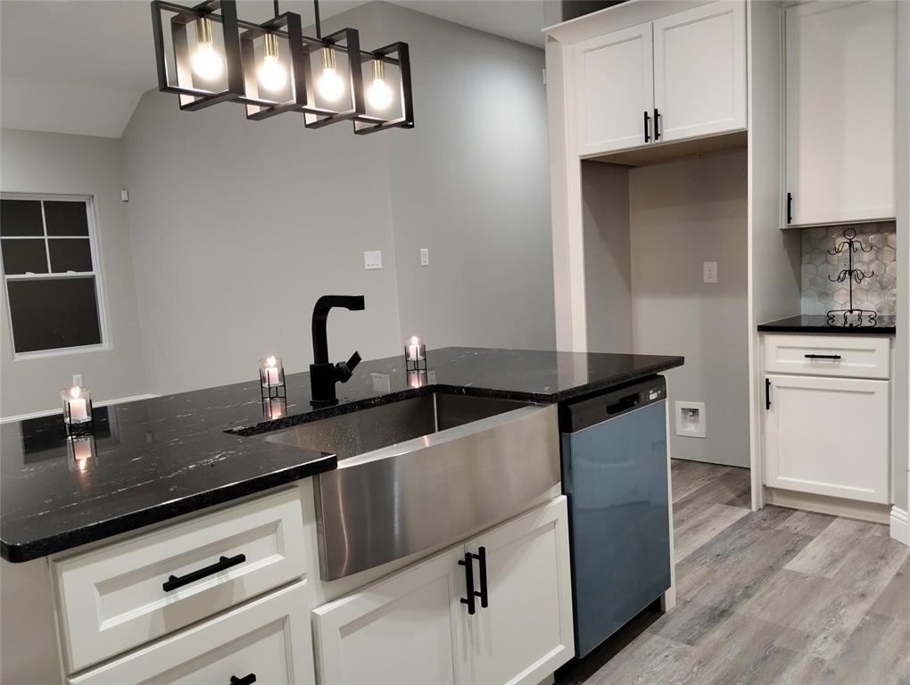 a kitchen with cabinets a sink and appliances