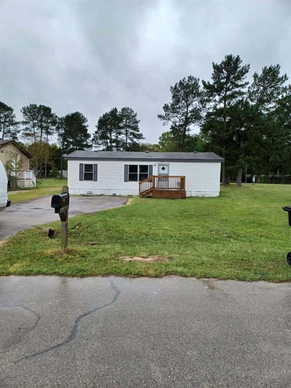 a view of a house with a yard and a garage