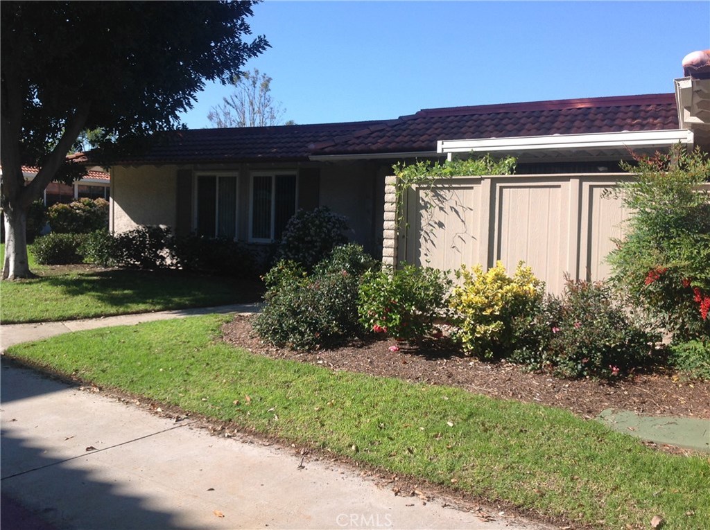 a front view of house with a garden