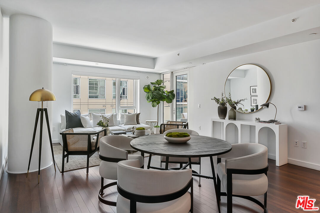 a view of a dining room with furniture window and wooden floor