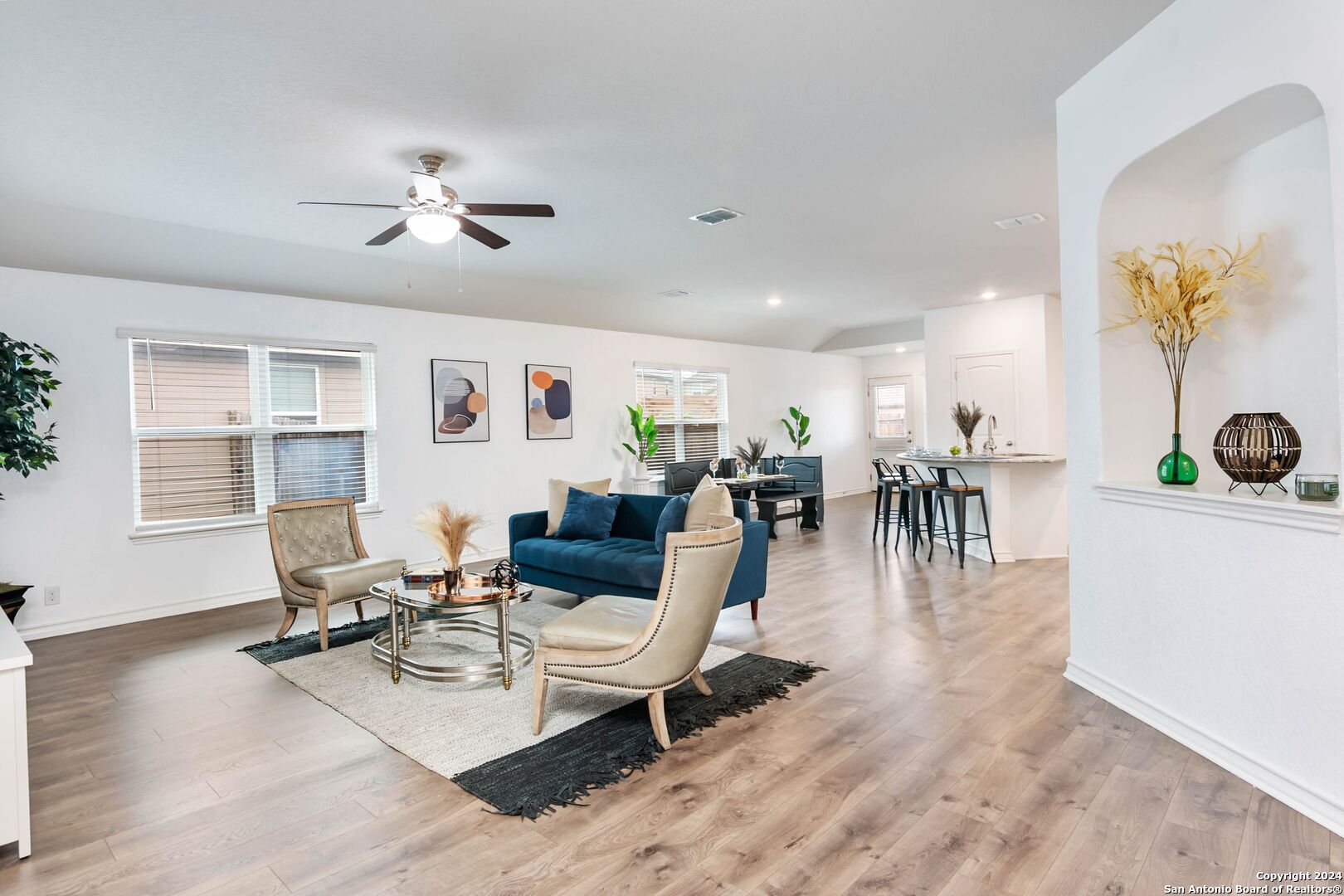 a living room with furniture a wooden floor and chandelier