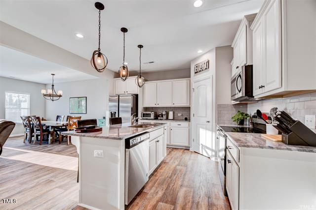 a kitchen with lots of counter top space and wooden floor