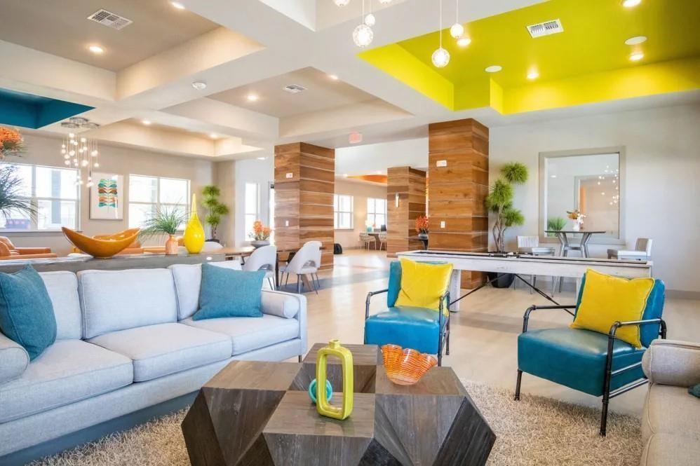 a living room with furniture and kitchen view