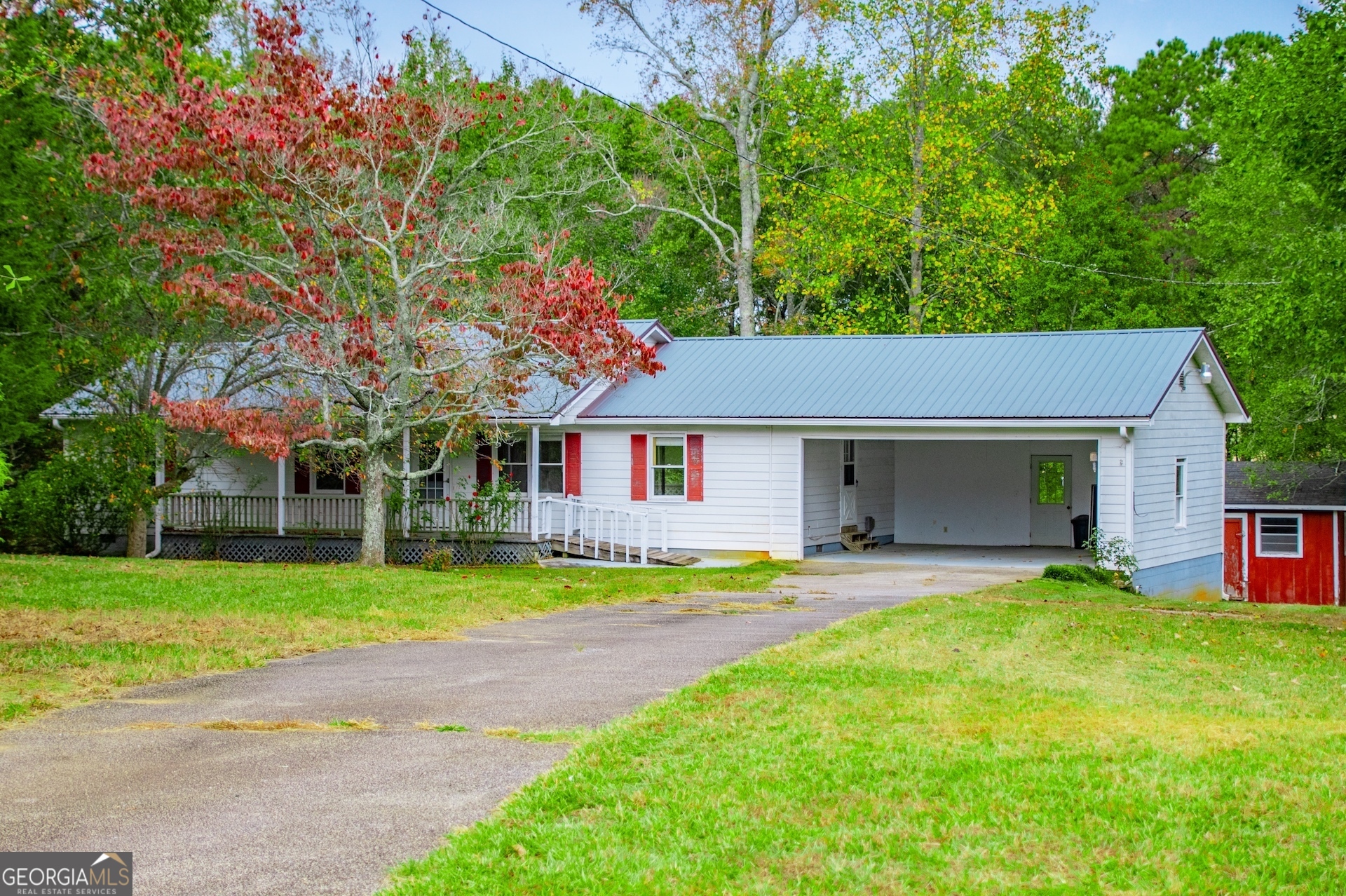 a front view of a house with a yard and trees