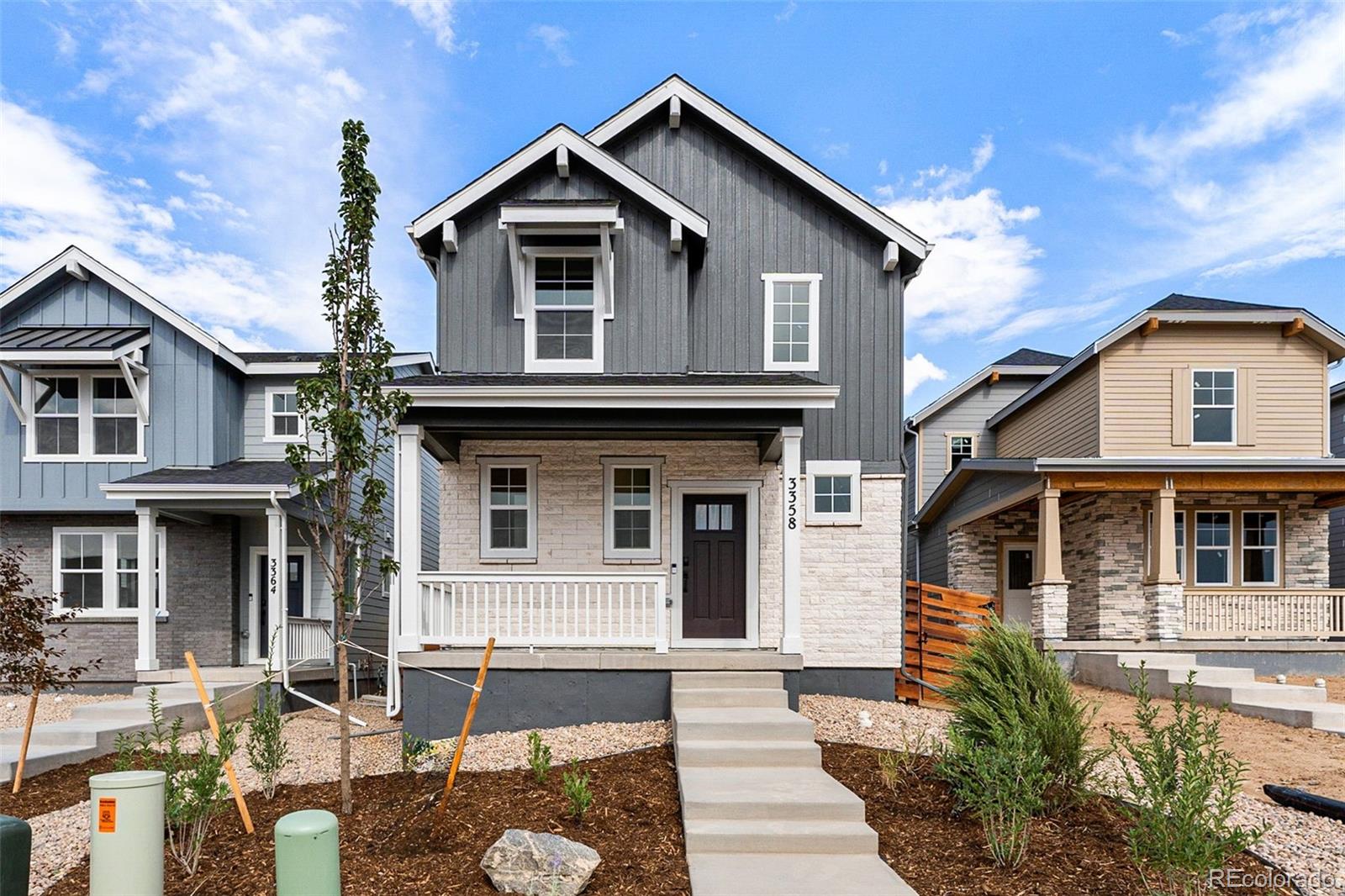 a front view of a house with yard and parking