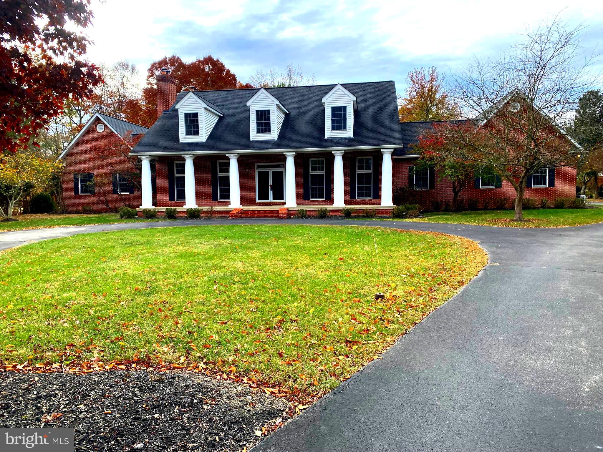 a view of a brick house with a yard