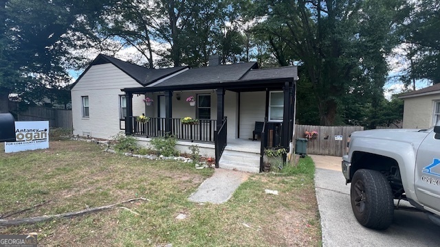 a view of a house with a porch and furniture