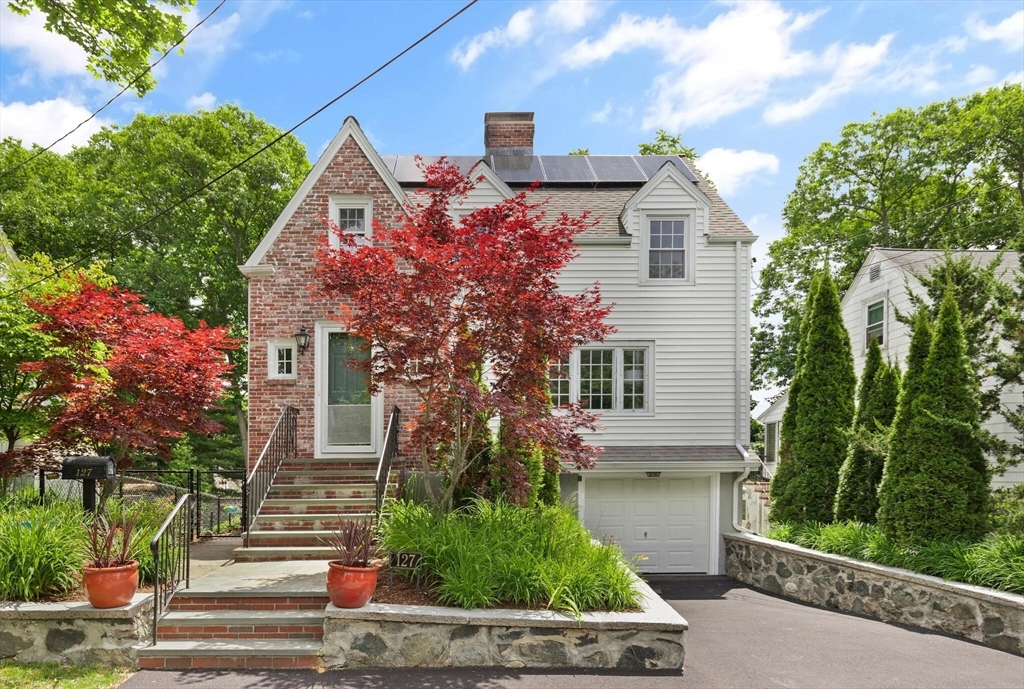 a front view of a house with garden