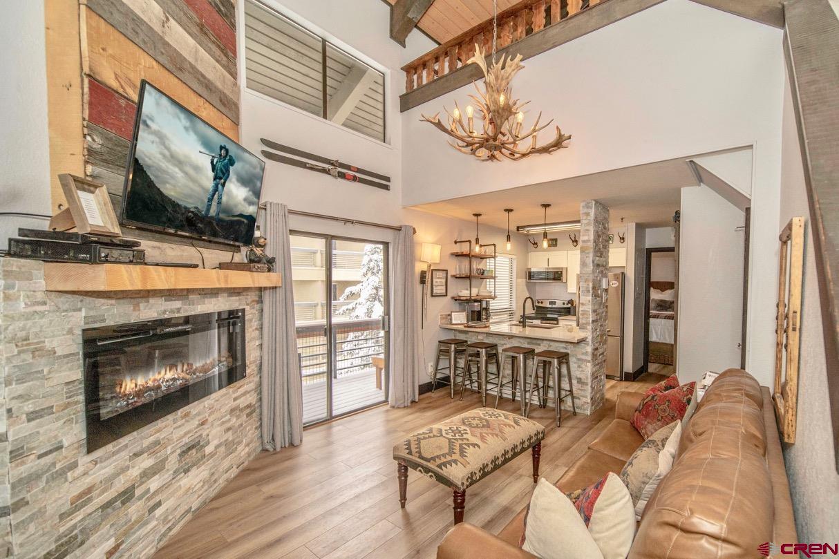 a living room with furniture a fireplace and a flat screen tv