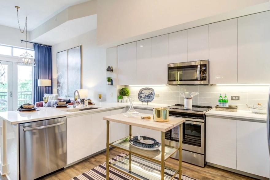 a kitchen with a sink stove top oven and microwave