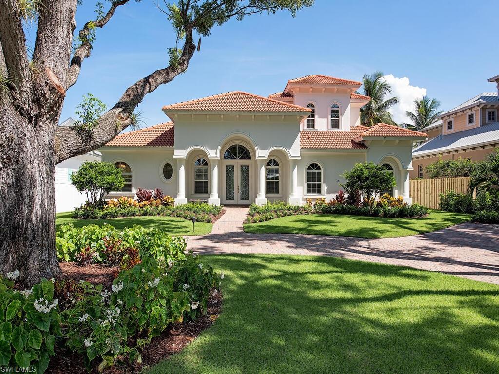 a front view of house with yard and green space