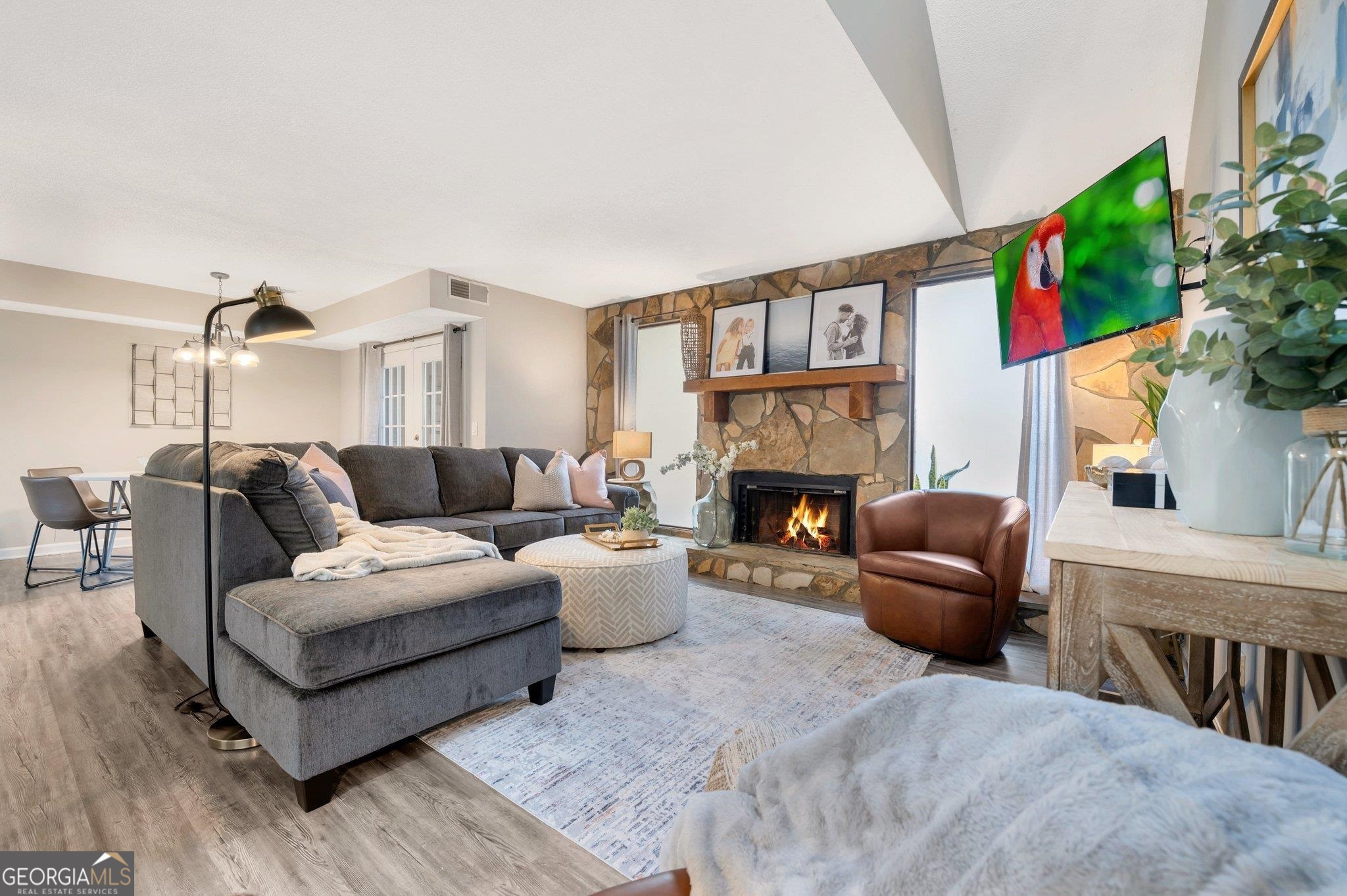 a living room with furniture a fireplace and a flat screen tv